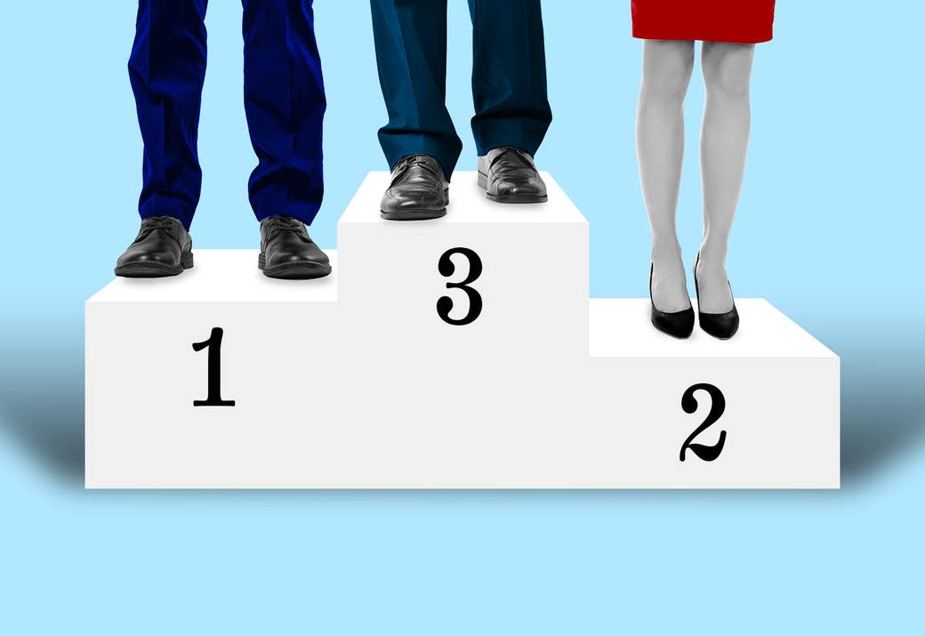 Three sets of legs stand on a podium, the top labeled &quot;3,&quot; the middle &quot;1,&quot; and the bottom &quot;2&quot;