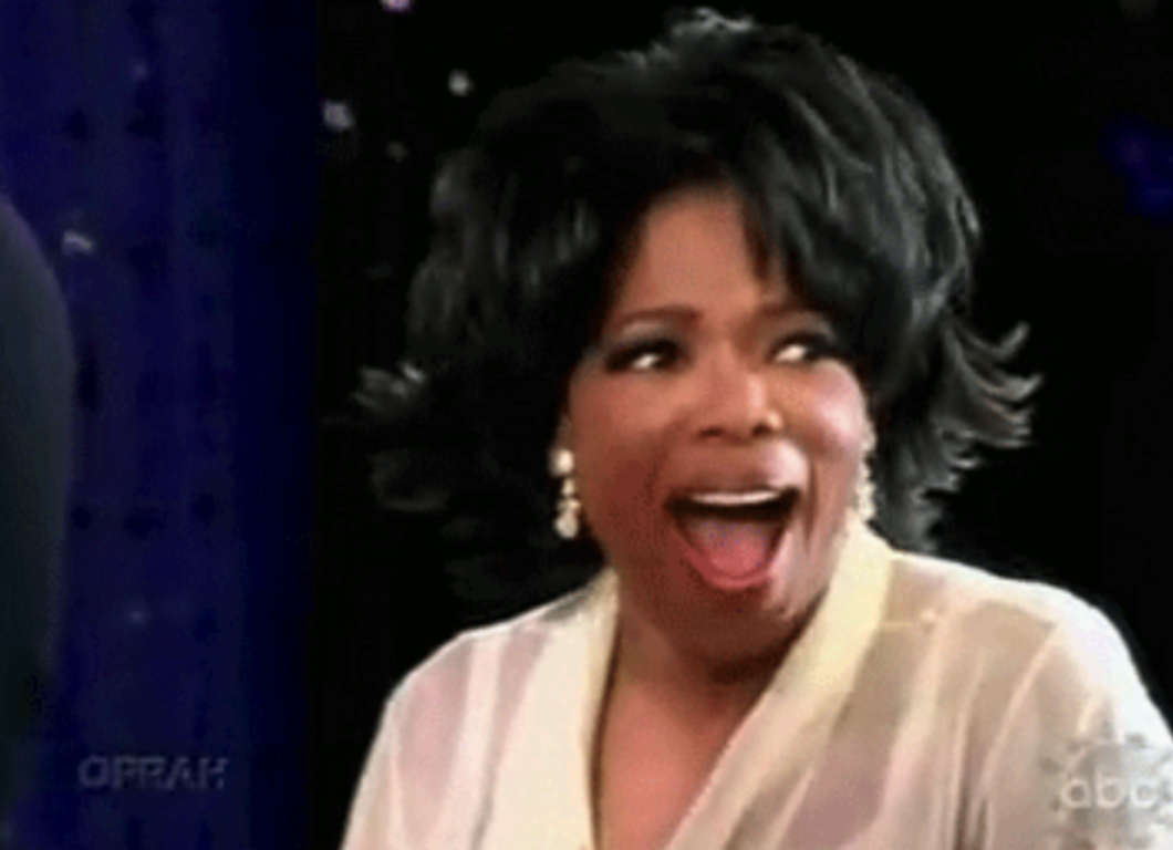 Oprah with her mouth wide open and looking amazed