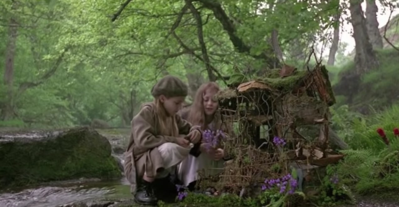 two girls in the forest near a fairy tree house