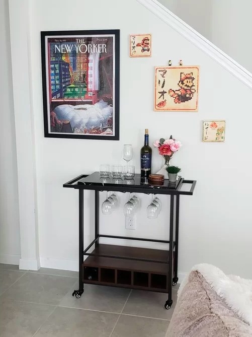 The bar cart with wine glasses and a wine bottle ready to be served