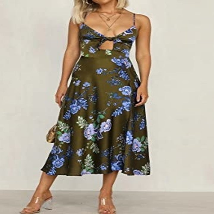 A person wearing the dress with strappy sandals