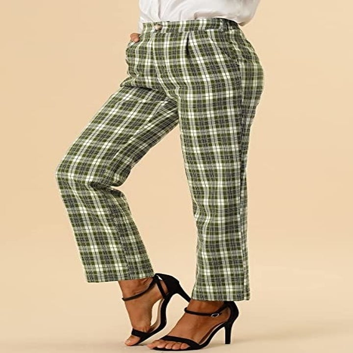 A person wearing the pants with a top and strappy sandals