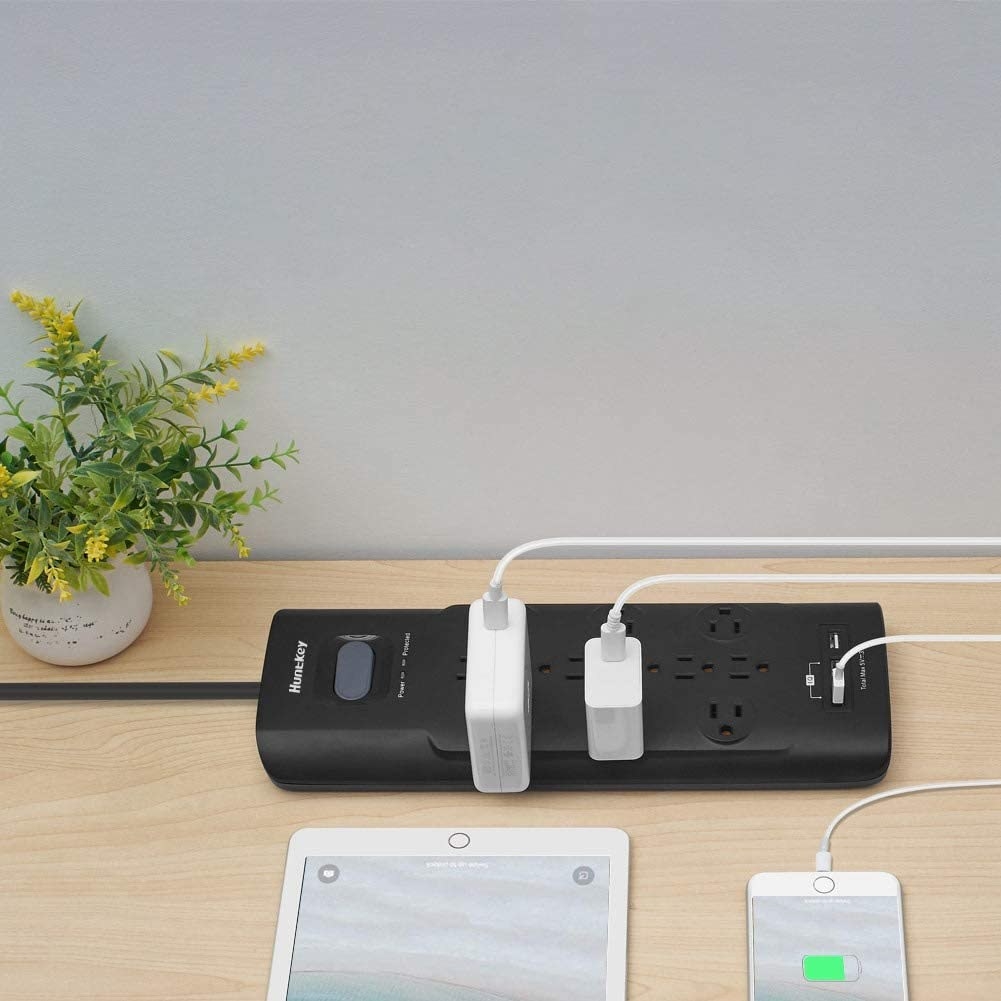 A long power bar with twelve outlets along with two USB ports