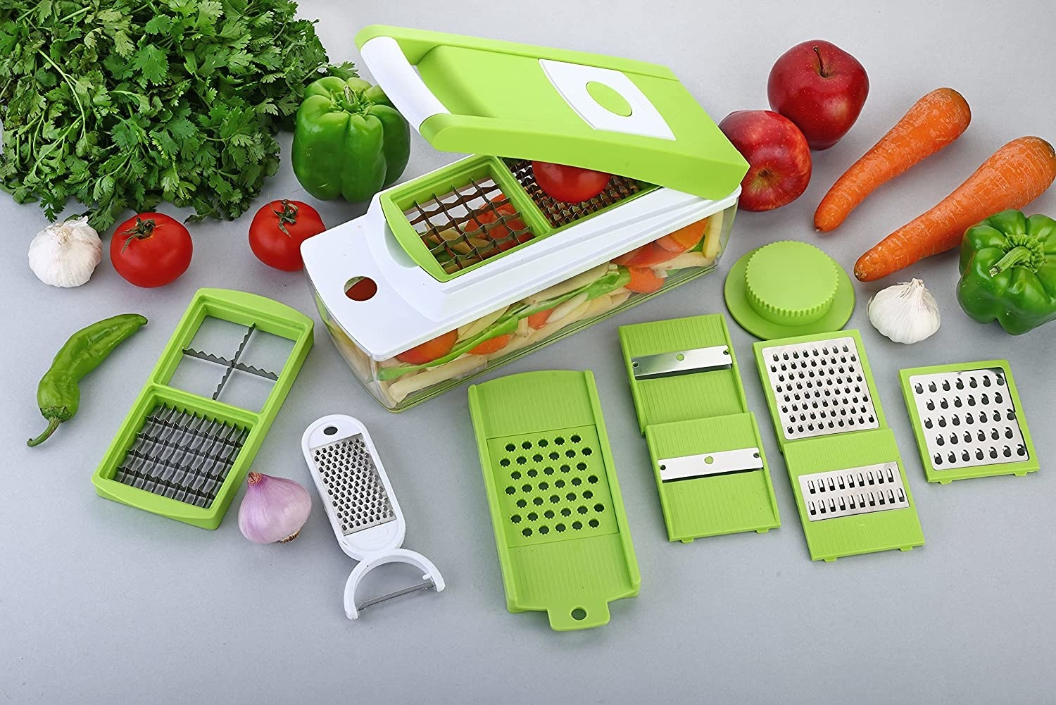 A vegetable chopper with different blades and vegetables