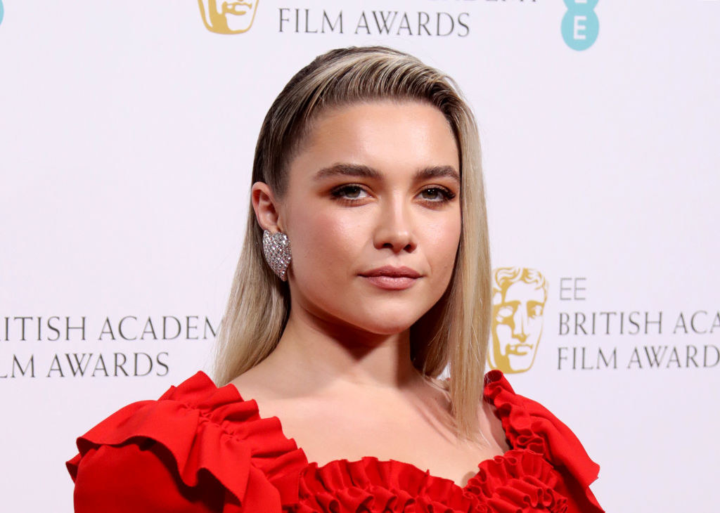 Florence Pugh in a frilly red top on the British Academy Film Awards red carpet