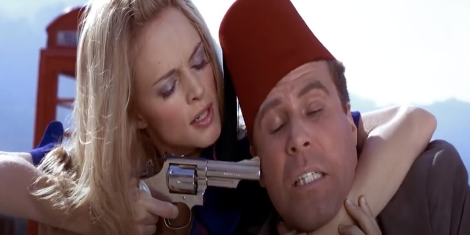 A close up of Mustafa as a gun is held to his head