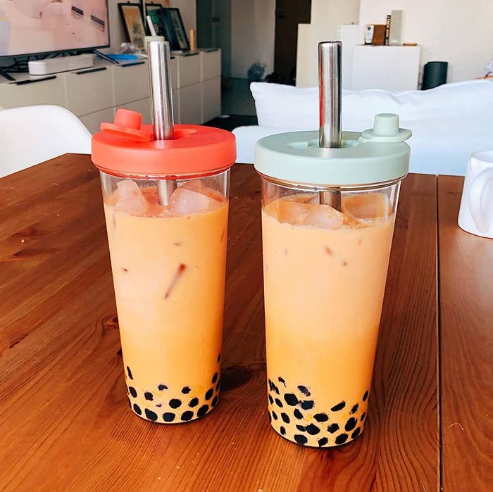 Two reusable boba cups filled with bubble tea