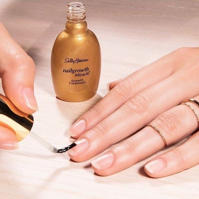 A person applying the treatment to their nails