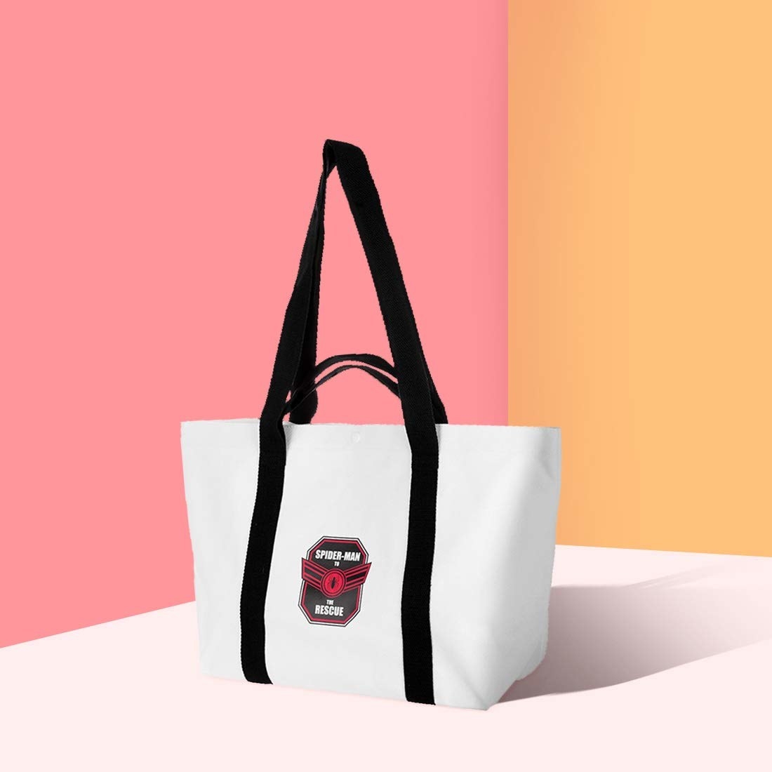 A white tote bag with a small emblem that says &#x27;Spiderman&#x27; to the rescue.