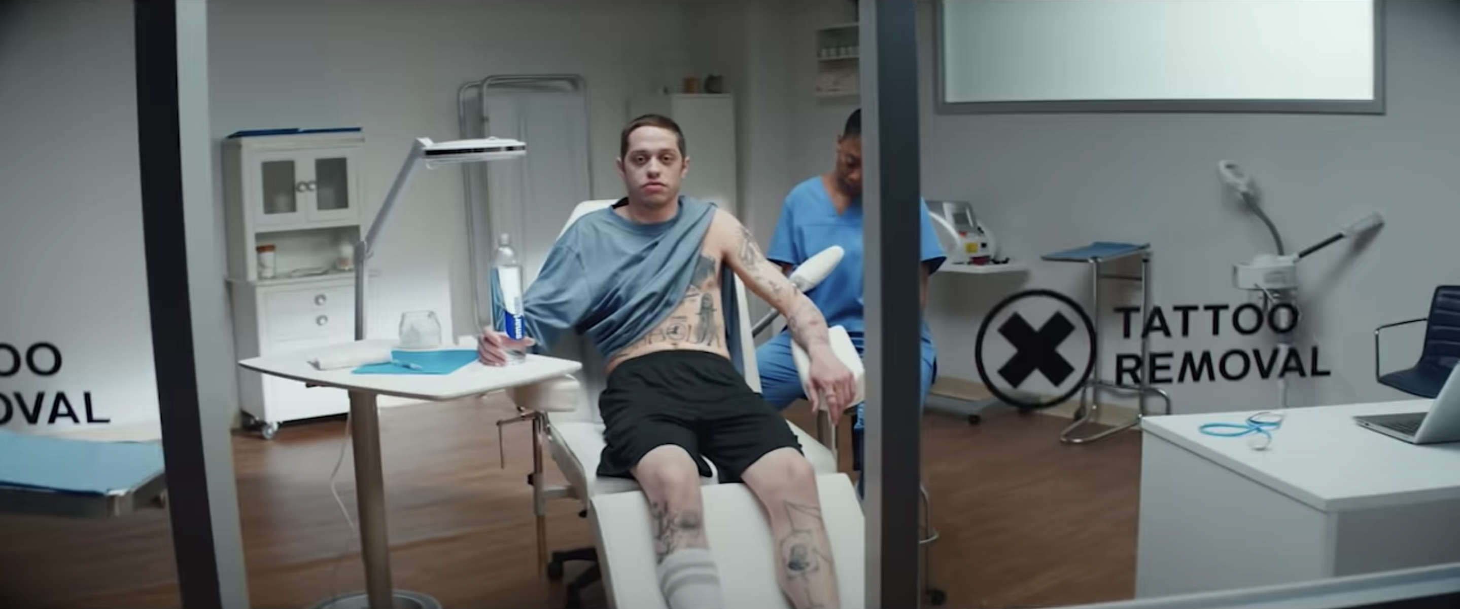 Pete Davidson poses in a tattoo removal clinic for a Smartwater ad