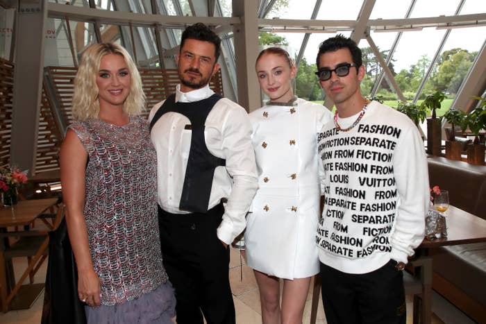 Katy Perry, Orlando Bloom, Sophie Turner, and Joe Jonas are photographed together at a Louis Vuitton event in Paris