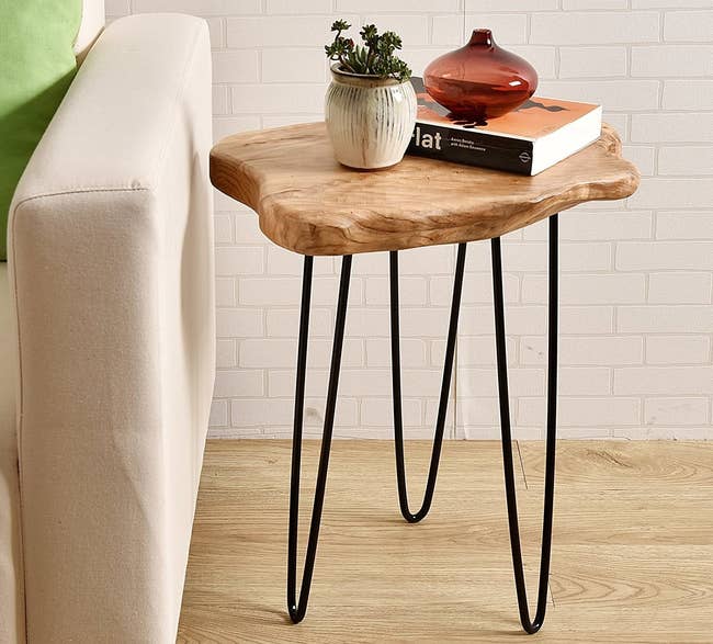 the side table with a natural edge wooden top with black steel legs