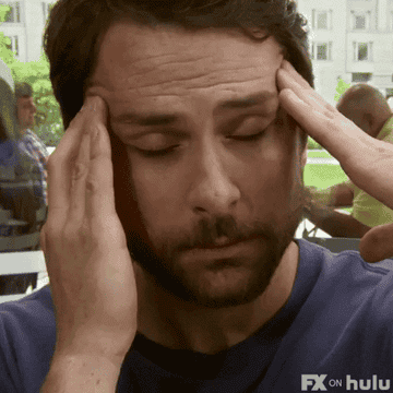 Charlie Day rubbing his head in frustration
