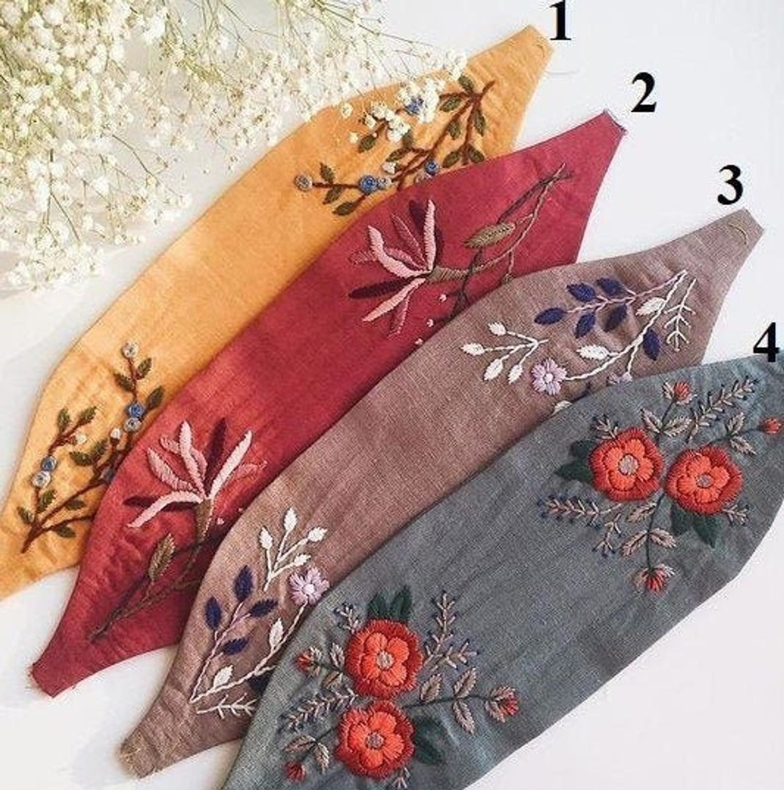 Four embroidered headbands in various colors