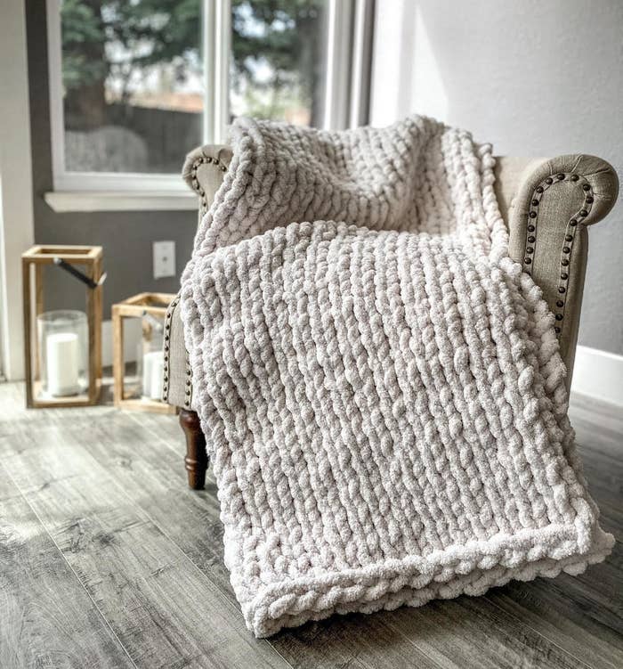 The chunky knit blanket in a cream color