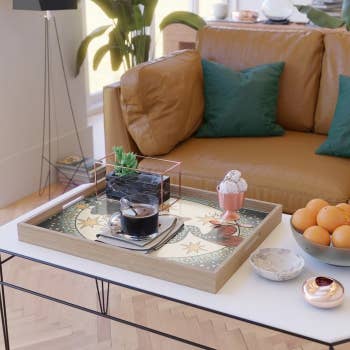 a living room with the serving tray sitting on a coffee table 