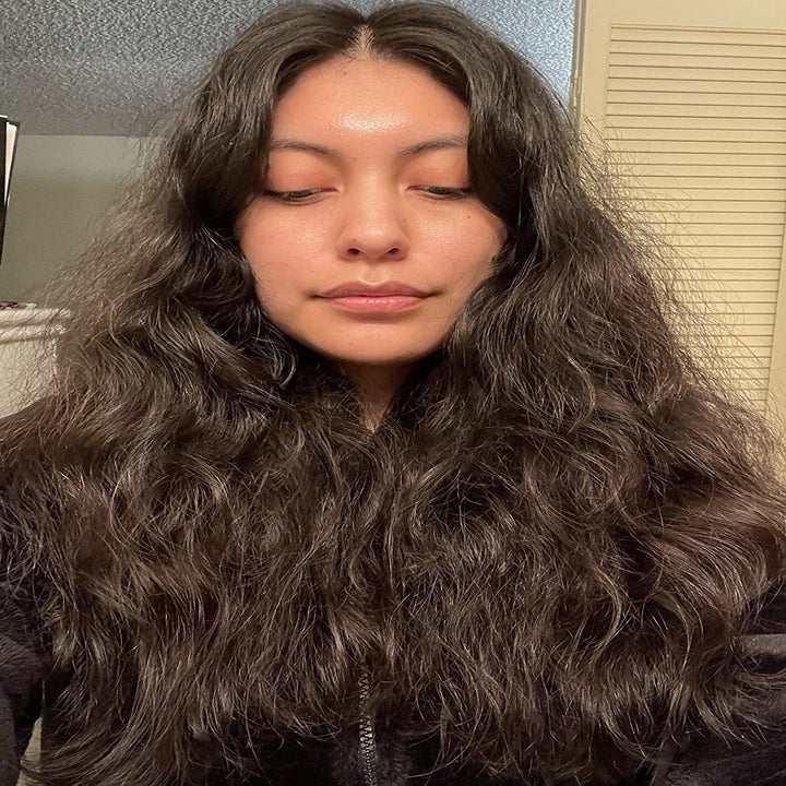 Reviewer showing curly hair before using brush