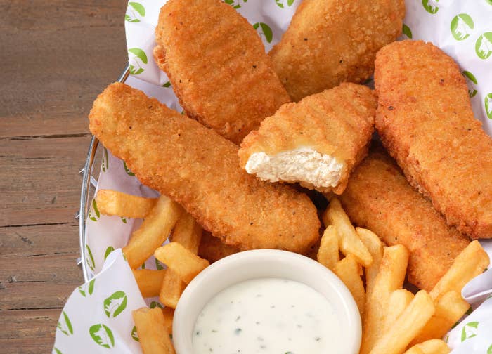 chicken nuggets in a basket with fries and dipping sauce