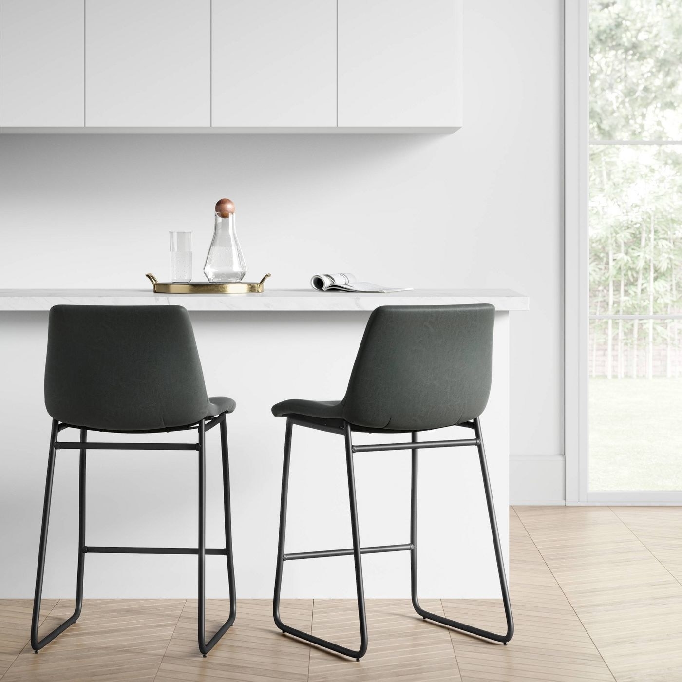 A set of two grey bar stools in front on a kitchen counter