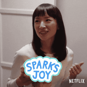 a gif of Marie Kondo looking excited