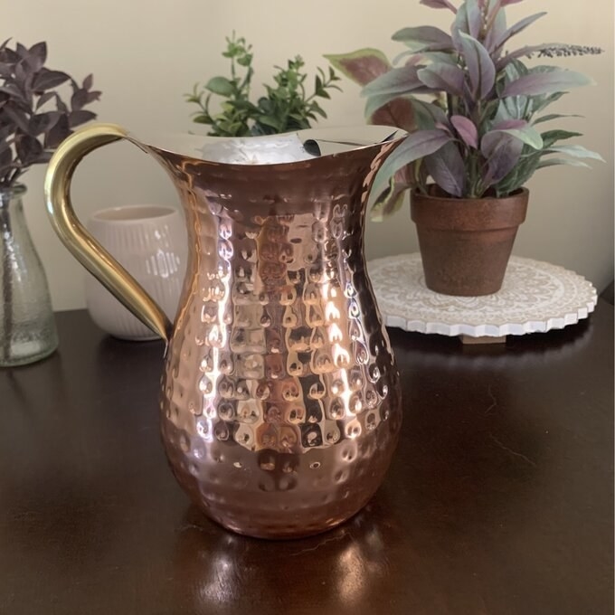 the copper pitcher on a counter