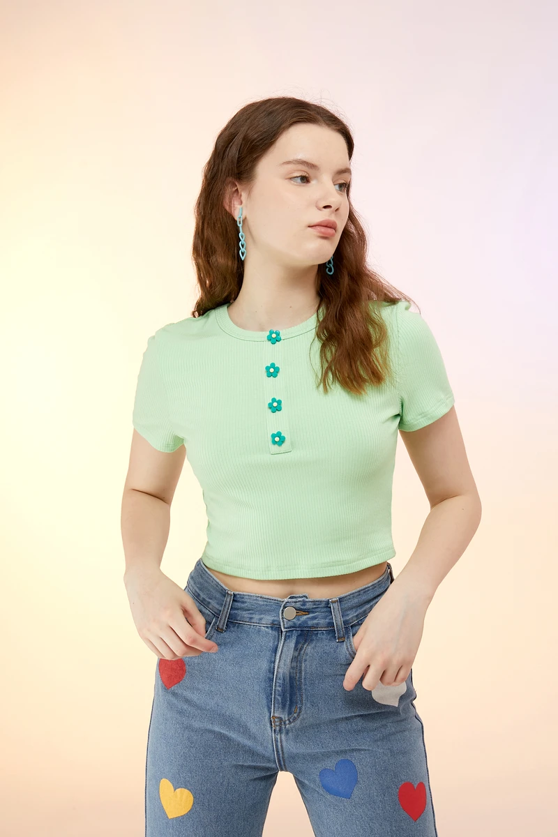 green short sleeve top with four flower non-functional buttons