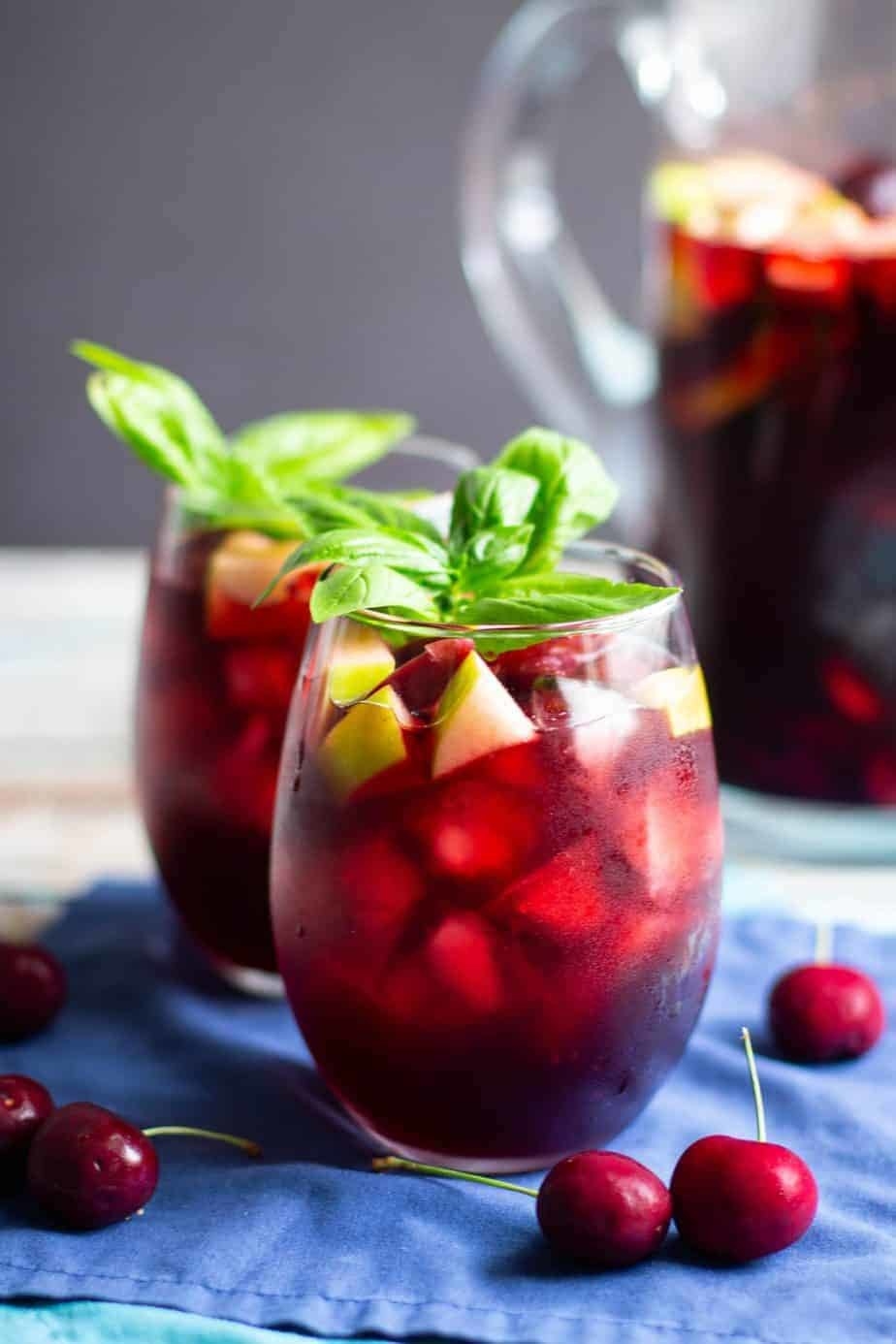 Red sangria in a stemless wine glass on a blue napkin. 