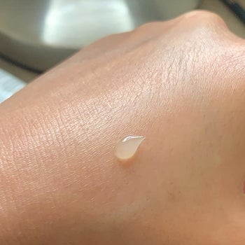 blob of transparent sunscreen on reviewer's hand