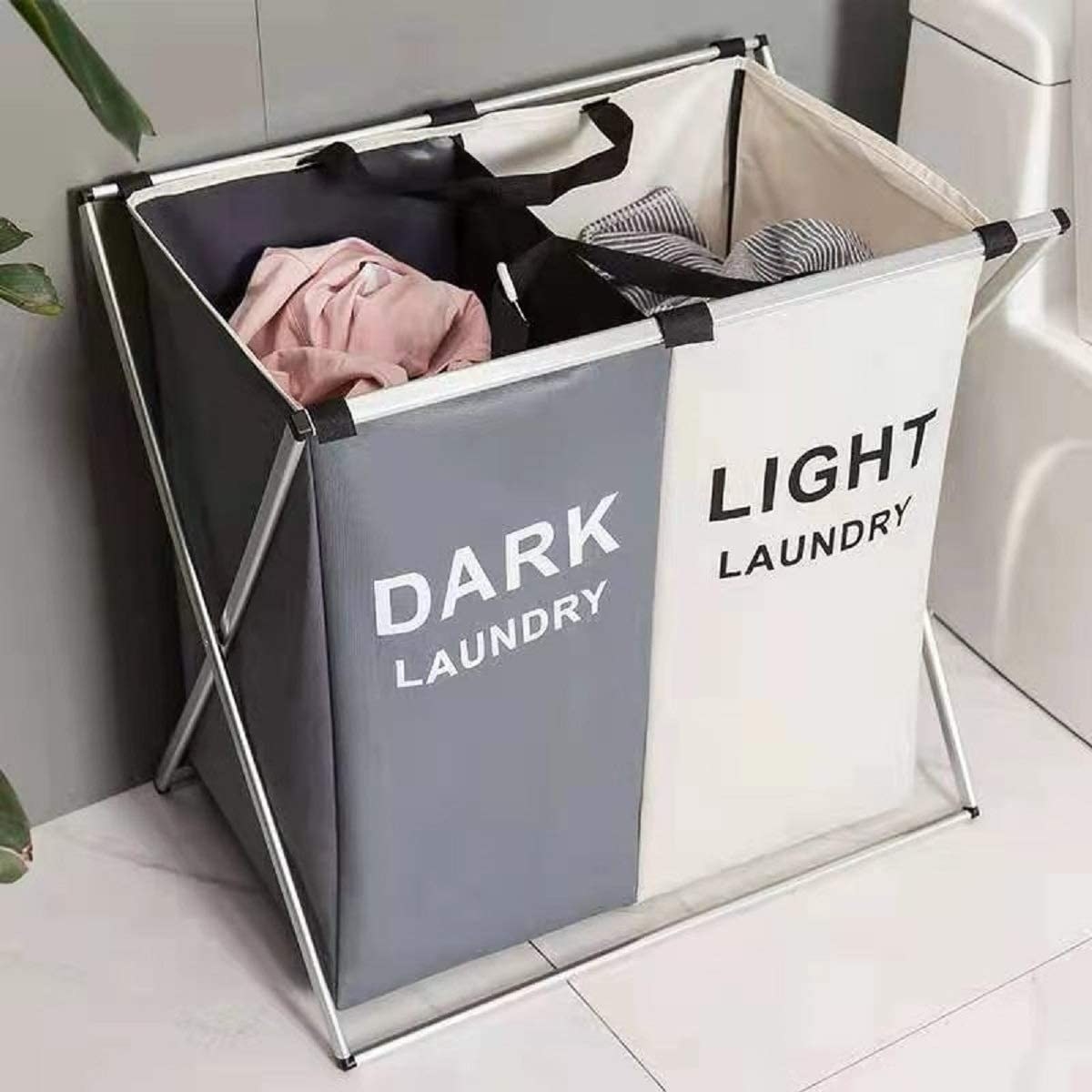 A large laundry hamper with two sections One side has dark written on it and the other has light laundry written on it