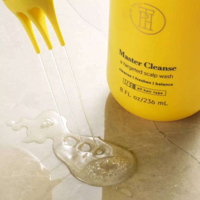 The bright yellow bottle says "TPH Master Cleanse" and the applicator is squeezing out the clear product