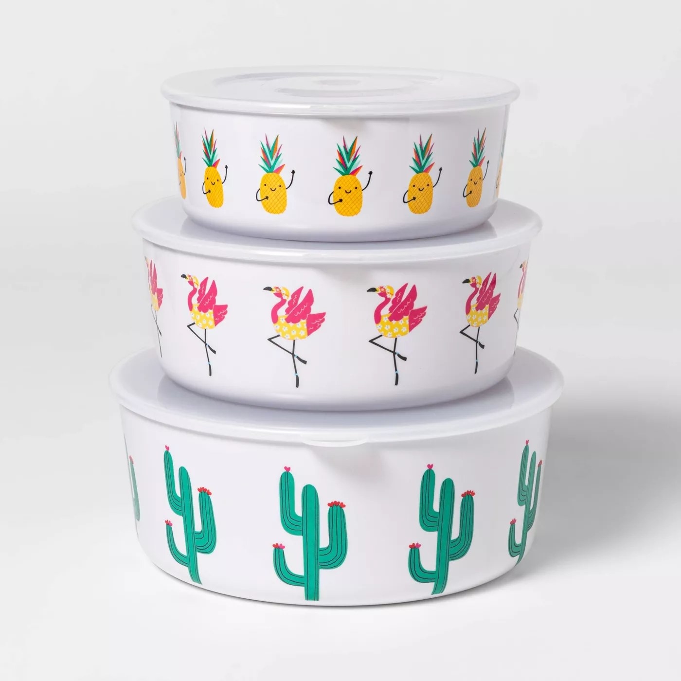 The bottom container has cacti, the middle one has flamingoes and the top one has pineapples with little faces