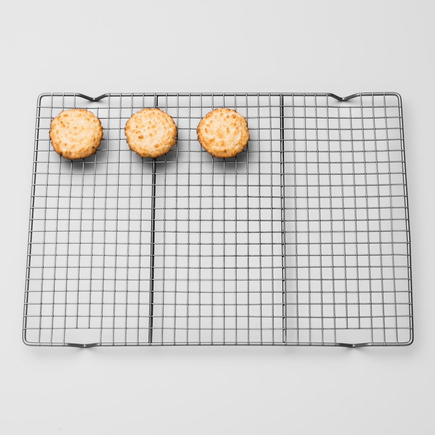 steel cooling rack with three cookies on top