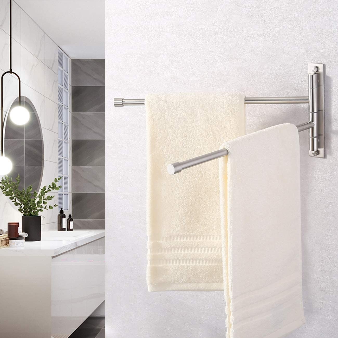 A metal towel rack with two bars that have towels hanging from them