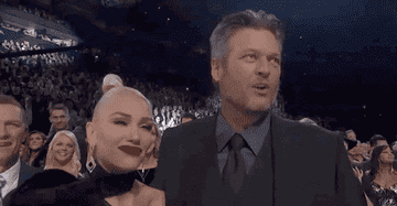 Blake Shelton and Gwen Stefani look at each other while attending the CMA Awards