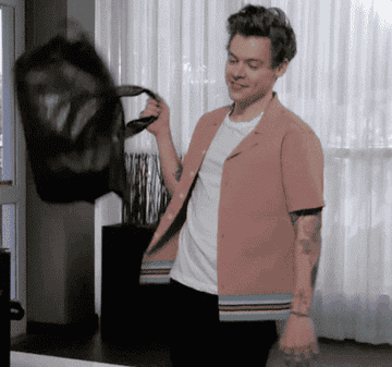 Harry Styles grabs a bag, mouths &quot;Thank you,&quot; and walks out of a room in this gif from &quot;The Late Late Show with James Corden&quot;