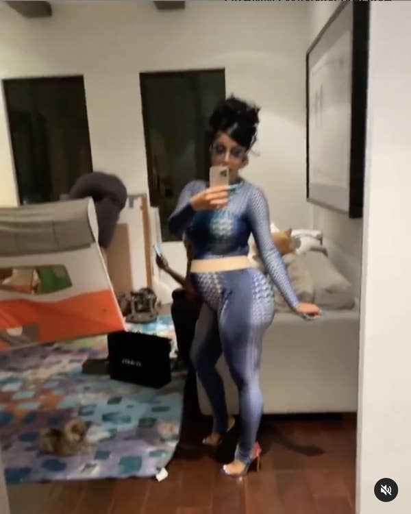 A side profile of Cardi in the bodysuit that shows she&#x27;s clearly pregnant