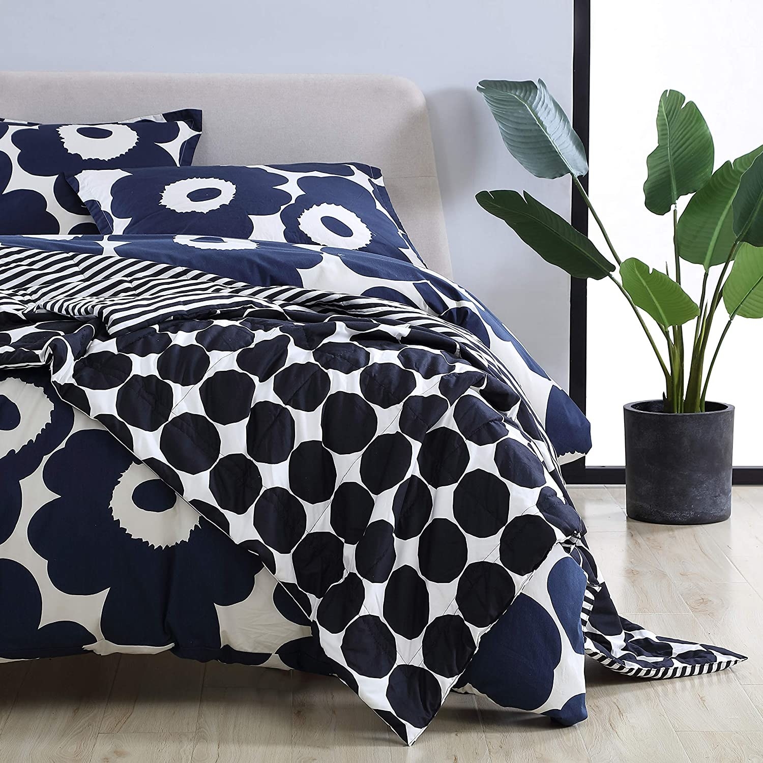 A Marimekko quilt draped over a large bed