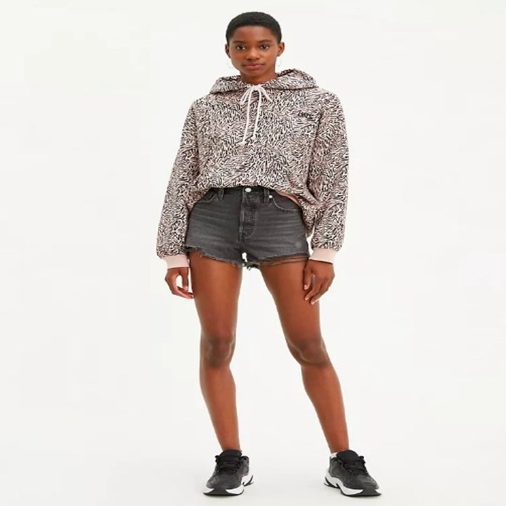 Model wearing the midi length gray shorts