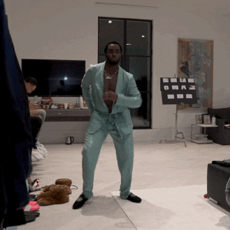 Diddy dances in silk pajamas in this gif