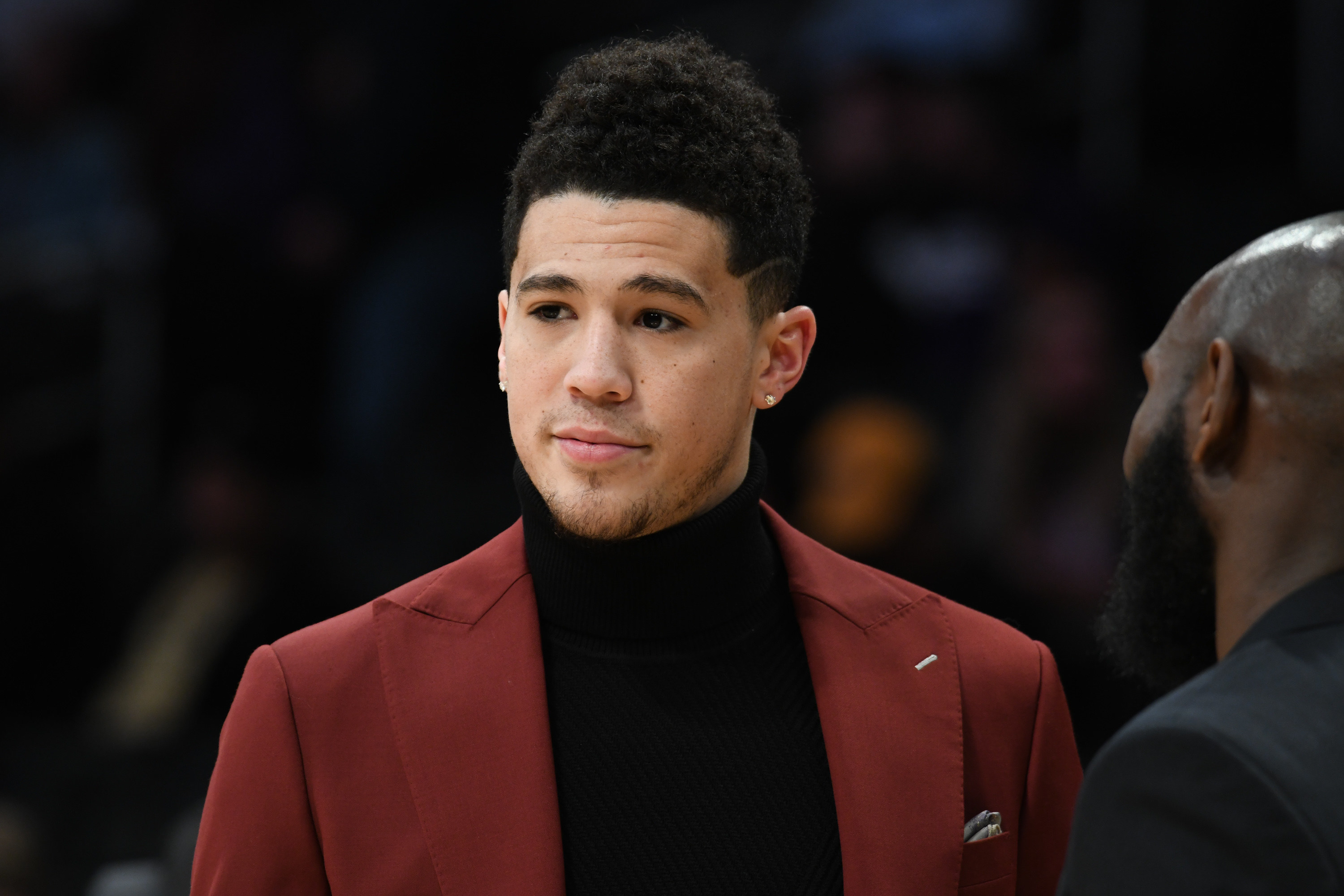 Devin Booker attends a basketball game between the Los Angeles Lakers and the Phoenix Suns at Staples Center on February 6, 2018 in Los Angeles, California