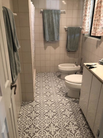 reviewer after image of the same bathroom with grey medina floor tiles on the floor
