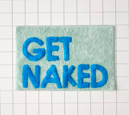 A colourful bath mat with the words "get naked" on it