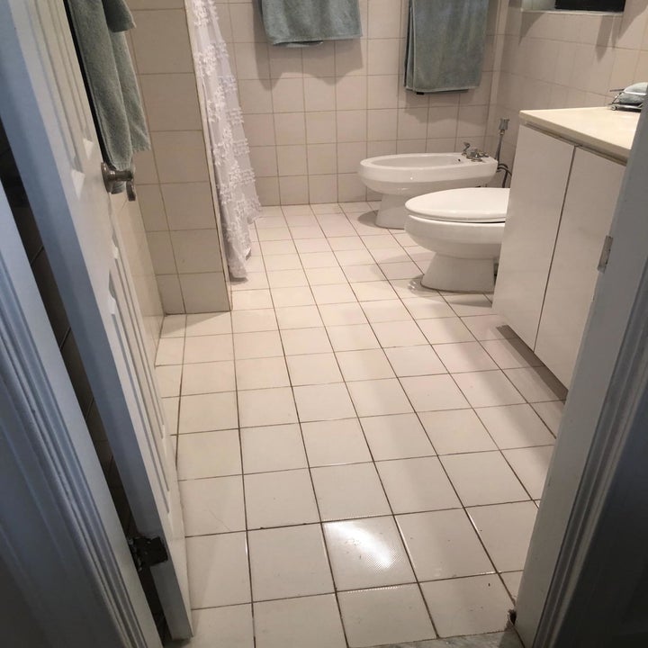 reviewer before image of a bathroom with white tiled floors