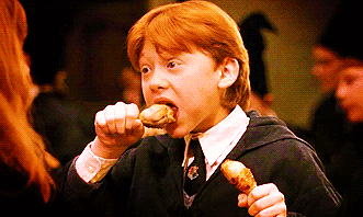 Ron Weasley eating a chicken drumstick.