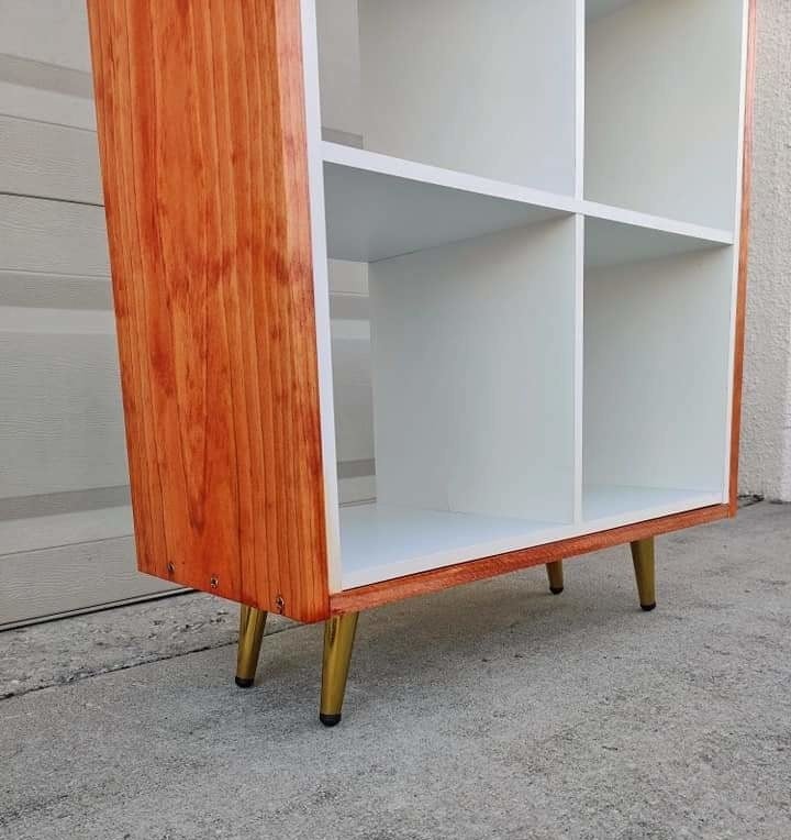 reviewer image of the gold leg replacements on an orange bookcase