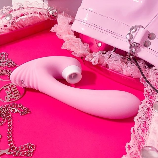 Pink vibrator surrounded by pink objects