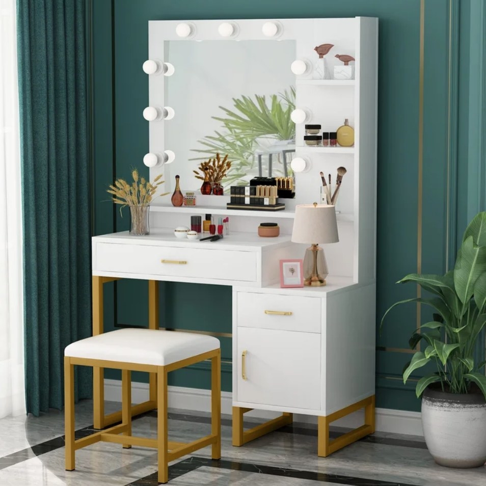 A white/gold vanity set with a stool and mirror with 9 LED lightbulbs, 2 drawers, a cabinet, and 6 shelves