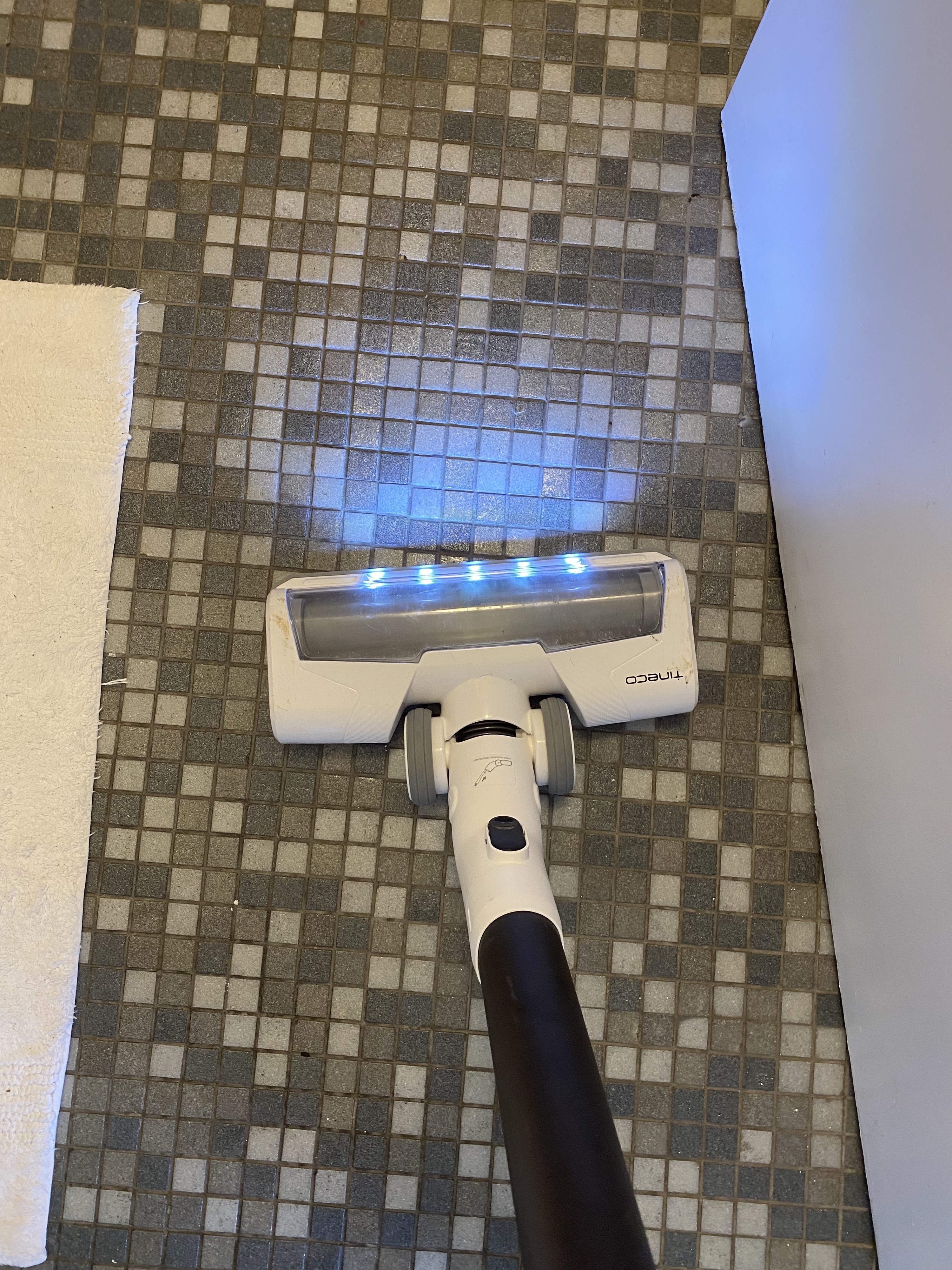 the Tineco being used on a tile bathroom floor