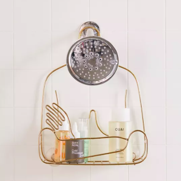 A wire shower caddy shaped like a person's torso with their arms crossed in front of their chest