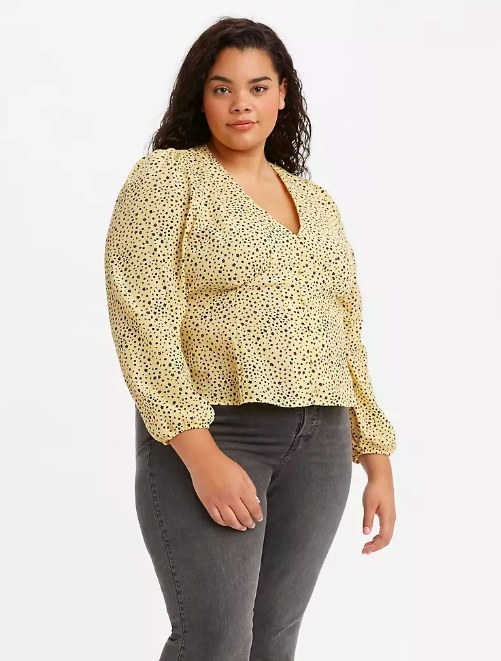 Model wearing the yellow patterned v-cut shirt